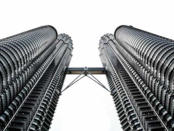 Looking up at the Petronas Twin Towers in Kuala Lumpur, connected by the skybridge between the towers.