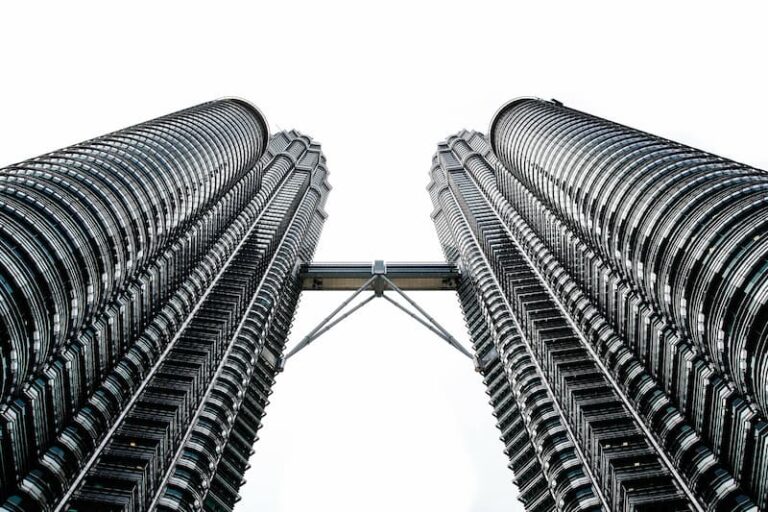 Looking up at the Petronas Twin Towers in Kuala Lumpur, connected by the skybridge between the towers.