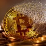 Golden Bitcoin coin resting on a pile of coins with a dispersing particle trail to the right, conveying cryptocurrency wealth.